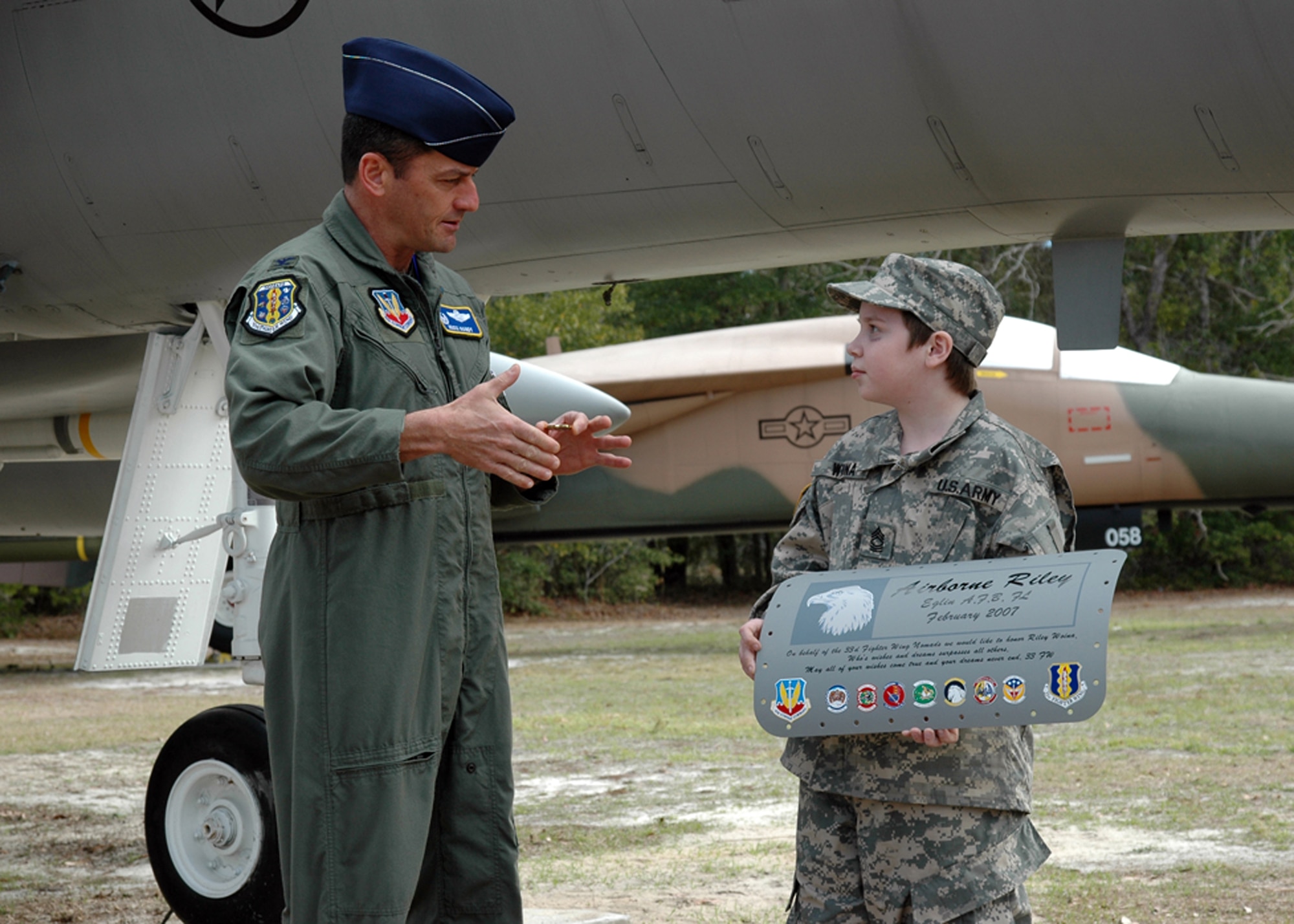 EGLIN AIR FORCE BASE, Fla. -- Col. Russ Handy, 33d Fighter Wing Commander, presents his commander?s coin to Riley Woina, 14, from Connecticut. Riley, diagnosed with cystic fibrosis, was granted a week with the 6th Ranger Training Battalion and Eglin Airmen through the Make-A-Wish Foundation Feb. 19-24. (USAF photo by Staff Sgt. Bryan Franks)