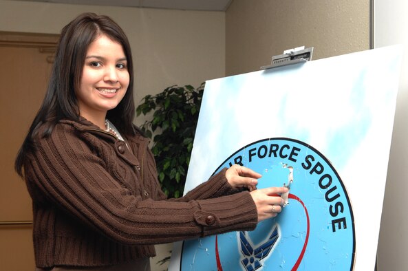 Ambrosia Banda, wife of Airman 1st Class Steven Banda of the 57th Equipment Maintenance Squadron, places a piece of the puzzle into the overall mission display during the Heart-Link Air Force 101 course for spouses. (U.S. Air Force photo/Airman 1st Class Nadine Barclay)