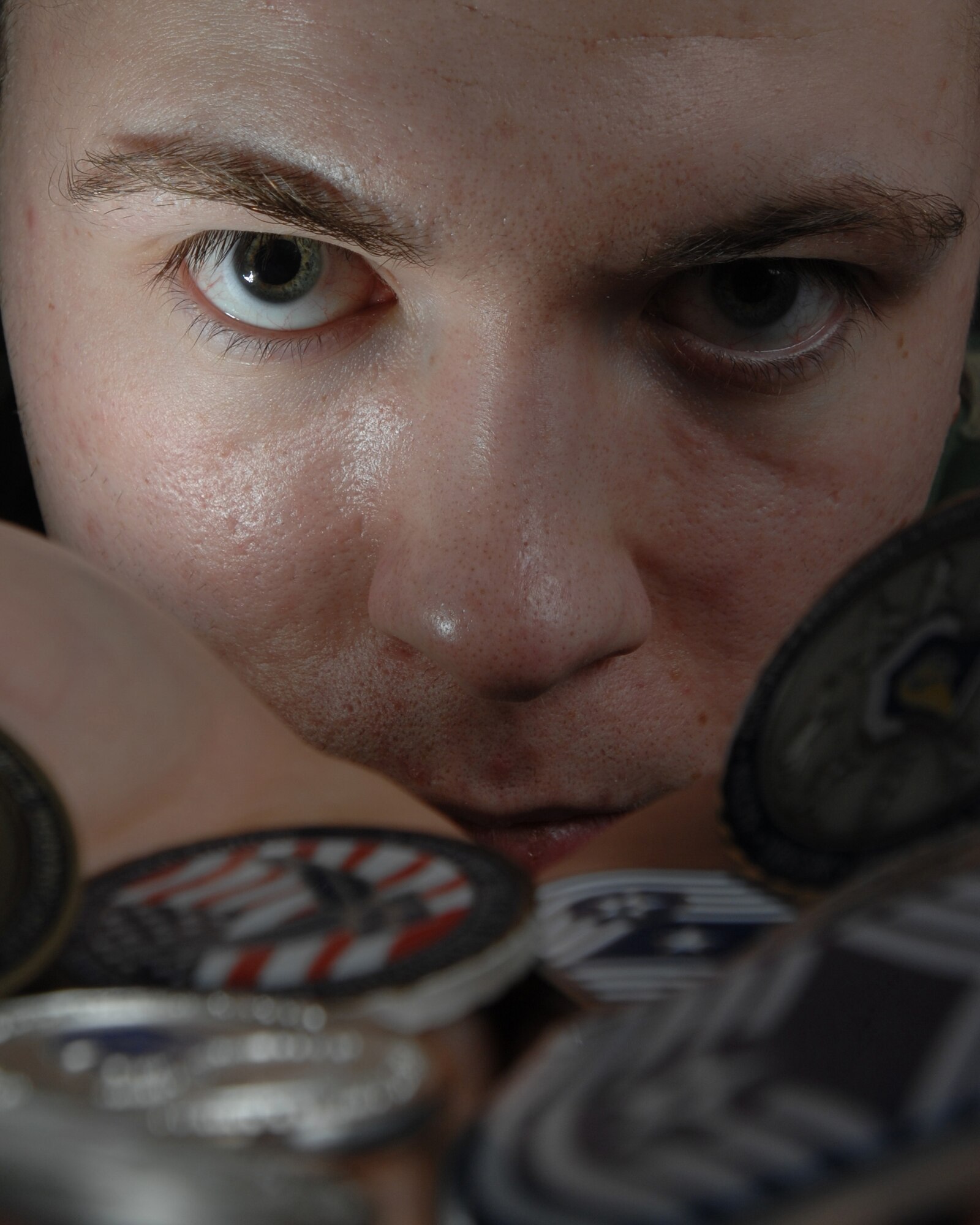 EIELSON AIR FORCE BASE, Alaska -- Airman 1st Class Christopher Griffin, 354th Communication Squadron displays his challenge coins. The challenge coin started during World War I when an American lieutenant ordered solid-bronze medallions and gave it to the pilots in his squadron. (U.S. Air Force photo by Airman 1st Class Jonathan Snyder) 
