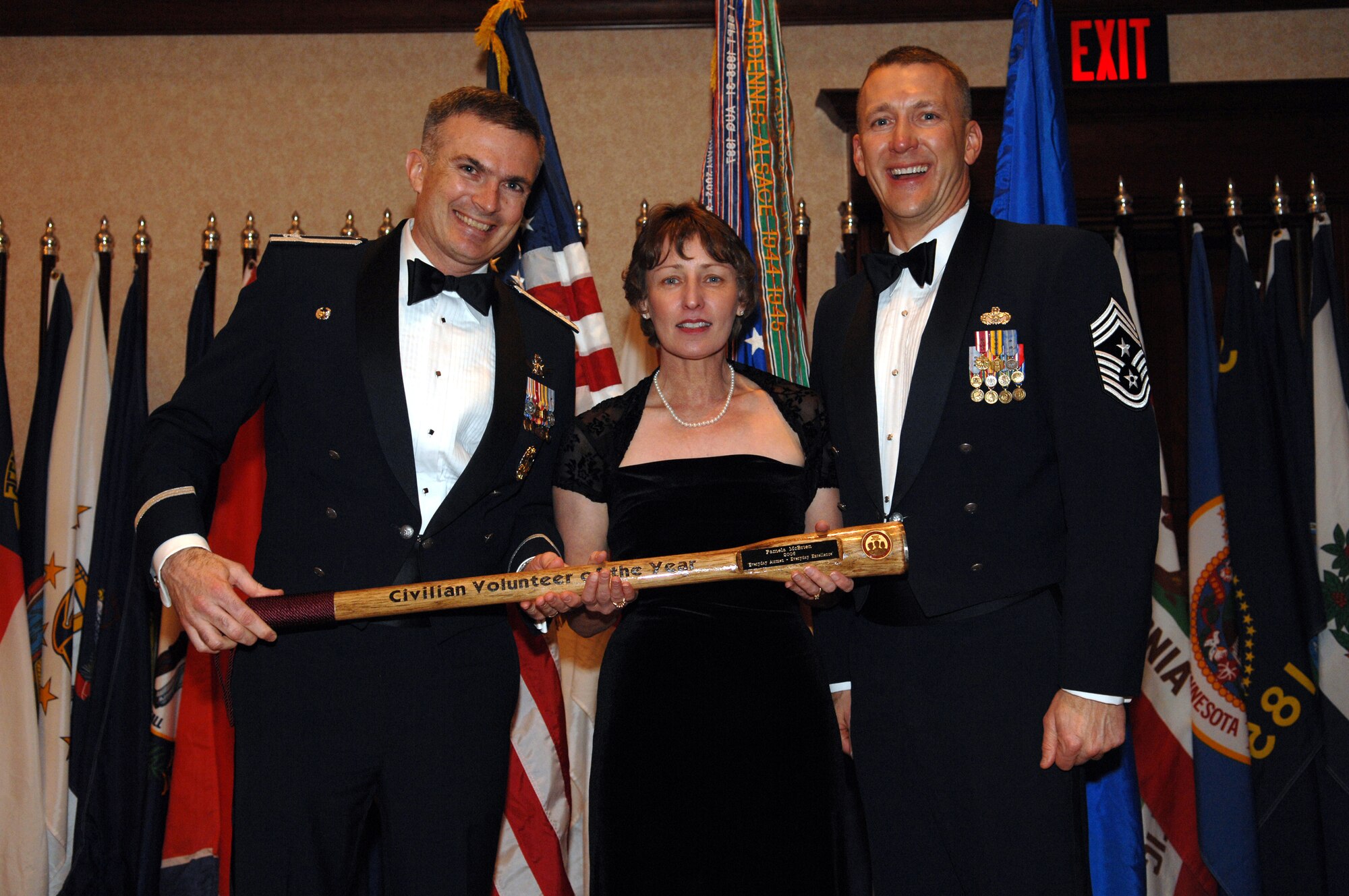 MINOT, N.D. – Col. Marty Whelan, 91st Space Wing commander, and Chief Master Sgt. Mark Brejcha, 91st SW command chief, present the Civilian Volunteer of the Year award to Pamela McBrien during the 91st SW Annual Awards Banquet at the Holiday Inn in Minot Feb. 23. With the theme, “Everyday Airmen, Everyday Excellence,” the 91st SW recognized award winners for their above-and-beyond leadership, job performance, self-improvement and community involvement. (U.S. Air Force photo by Airman 1st Class Cassandra Butler)  