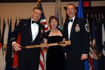 MINOT, N.D. – Col. Marty Whelan, 91st Space Wing commander, and Chief Master Sgt. Mark Brejcha, 91st SW command chief, present the Civilian Volunteer of the Year award to Pamela McBrien during the 91st SW Annual Awards Banquet at the Holiday Inn in Minot Feb. 23. With the theme, “Everyday Airmen, Everyday Excellence,” the 91st SW recognized award winners for their above-and-beyond leadership, job performance, self-improvement and community involvement. (U.S. Air Force photo by Airman 1st Class Cassandra Butler)  