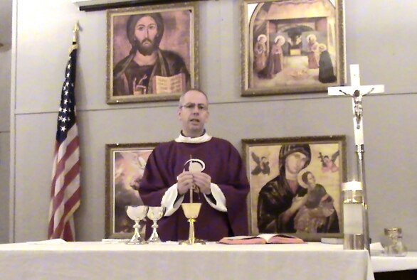 Chaplain (Capt.) James A. Hamel celebrates Mass at Ali Base, Iraq, where he was deployed from September 2006 to January 2007. Father Hamel, a Catholic chaplain assigned to the 11th Wing at Bolling, said he found troop morale at Ali Base the best he has encountered in his three deployments to the region, which included postings to Kuwait, Qatar and the United Arab Emirates.
