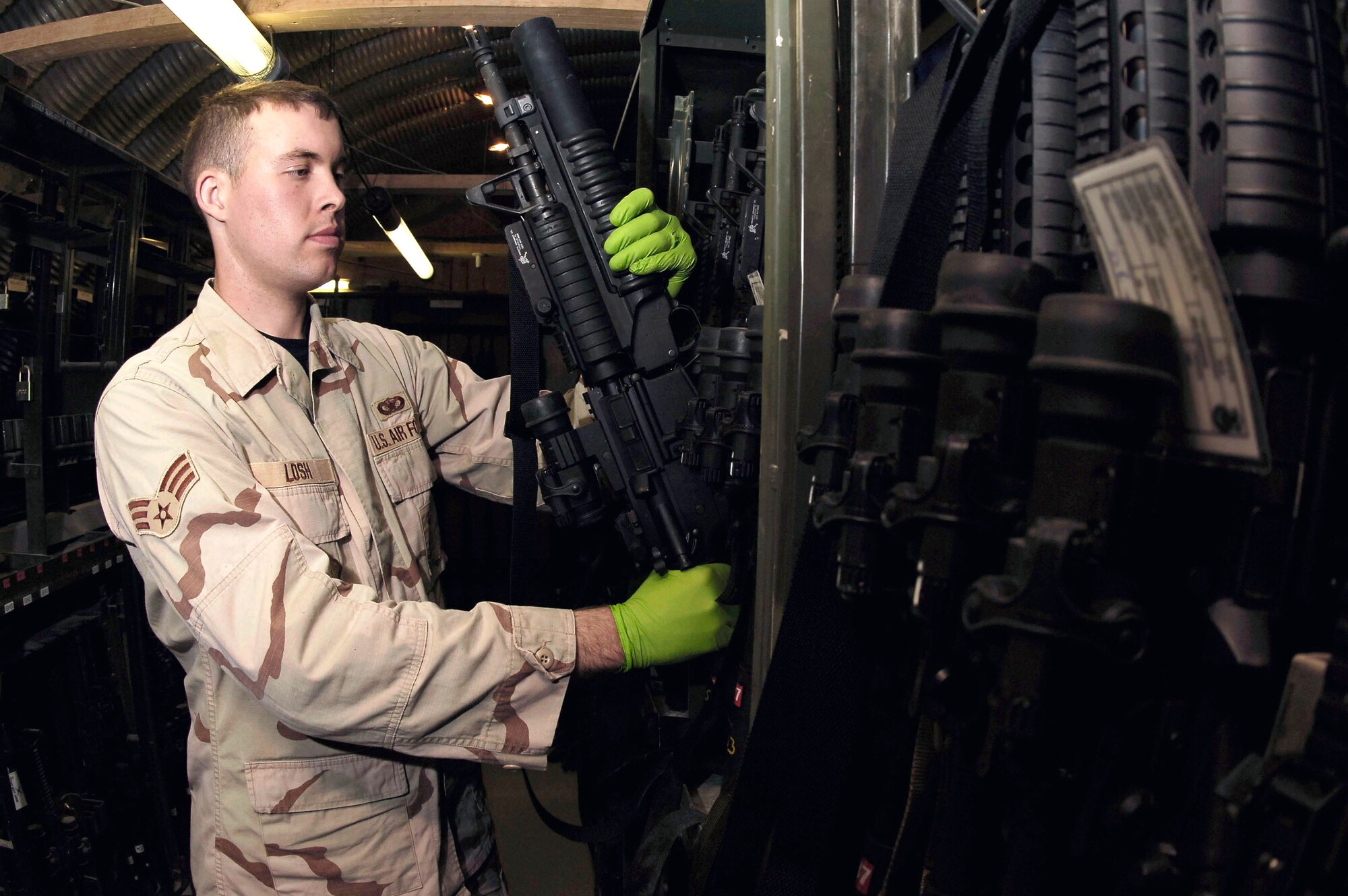 Senior Airman Allen Losh checks weapons in the armory Feb. 19 at Kirkuk Air Base, Iraq. Airman Losh is a member of the 506th Expeditionary Security Forces Squadron. (U.S. Air Force photo/Senior Airman Bradley Lail) 