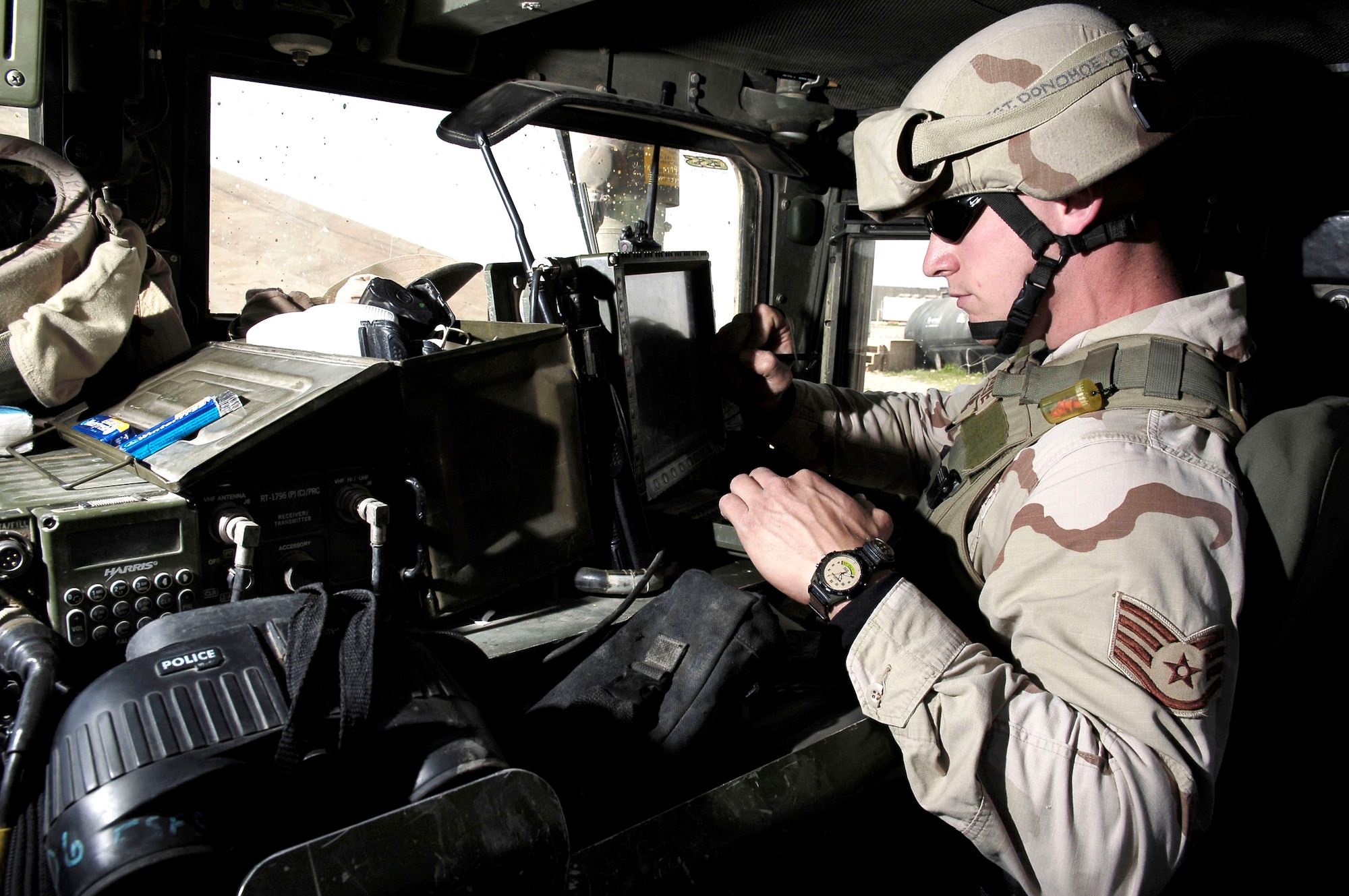 Staff Sgt. Patrick Donohoe checks a tracking monitor Feb. 13 at Kirkuk Air Base, Iraq, that shows the location of all friendly units and possible hazards in the area. It also observes all enemy contact. Sergeant Donohoe is a member of the Quick Reaction Force, or QRF, team with the 506th Expeditionary Security Forces Squadron. (U.S. Air Force photo/Senior Airman Bradley Lail) 