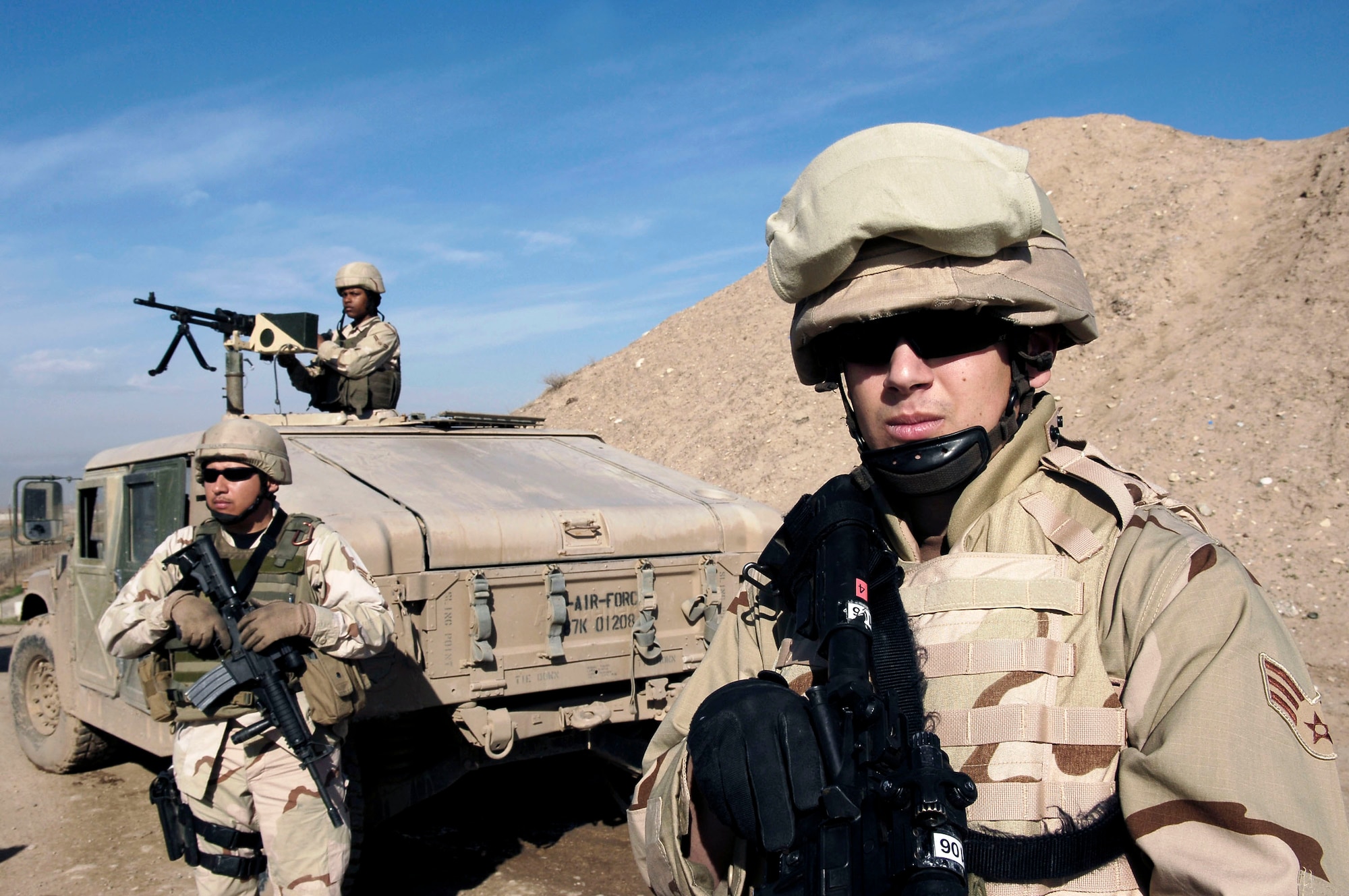 Senior Airmen Joshua Ramos and Alberto Nava and Airman 1st Class Shequita Spence (manning machine gun) conduct perimeter scans Feb. 13 at Kirkuk Air Base, Iraq.  These Airmen, providing perimeter security for the base, are members of the 506th Expeditionary Security Forces Squadron. (U.S. Air Force photo/Senior Airman Bradley Lail) 
