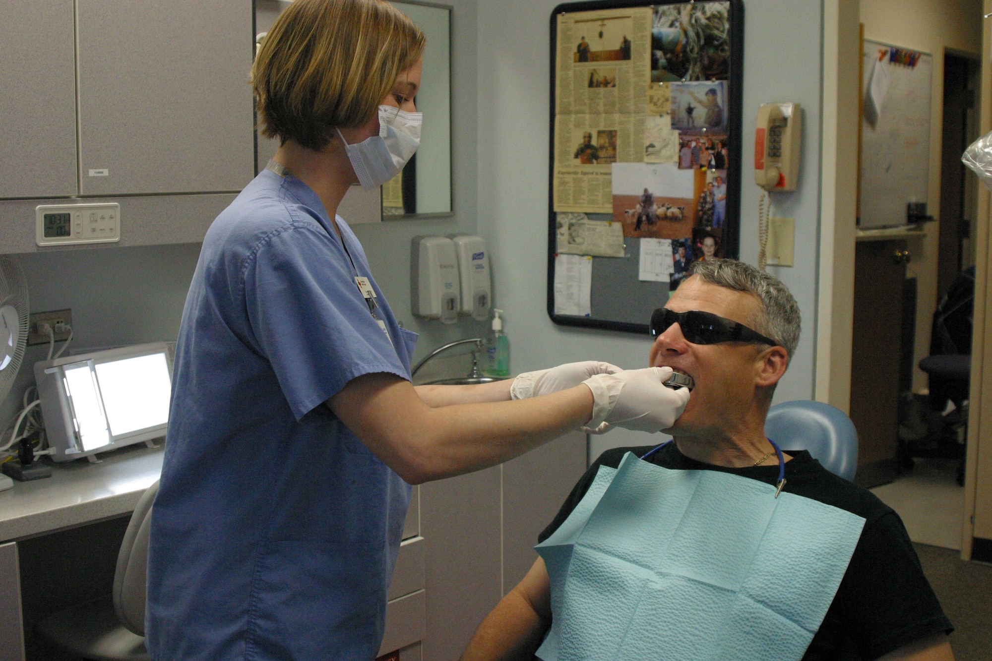 A Red Cross dental assistant trainee practices taking impressions on Tech. Sgt. Joseph Riffle.