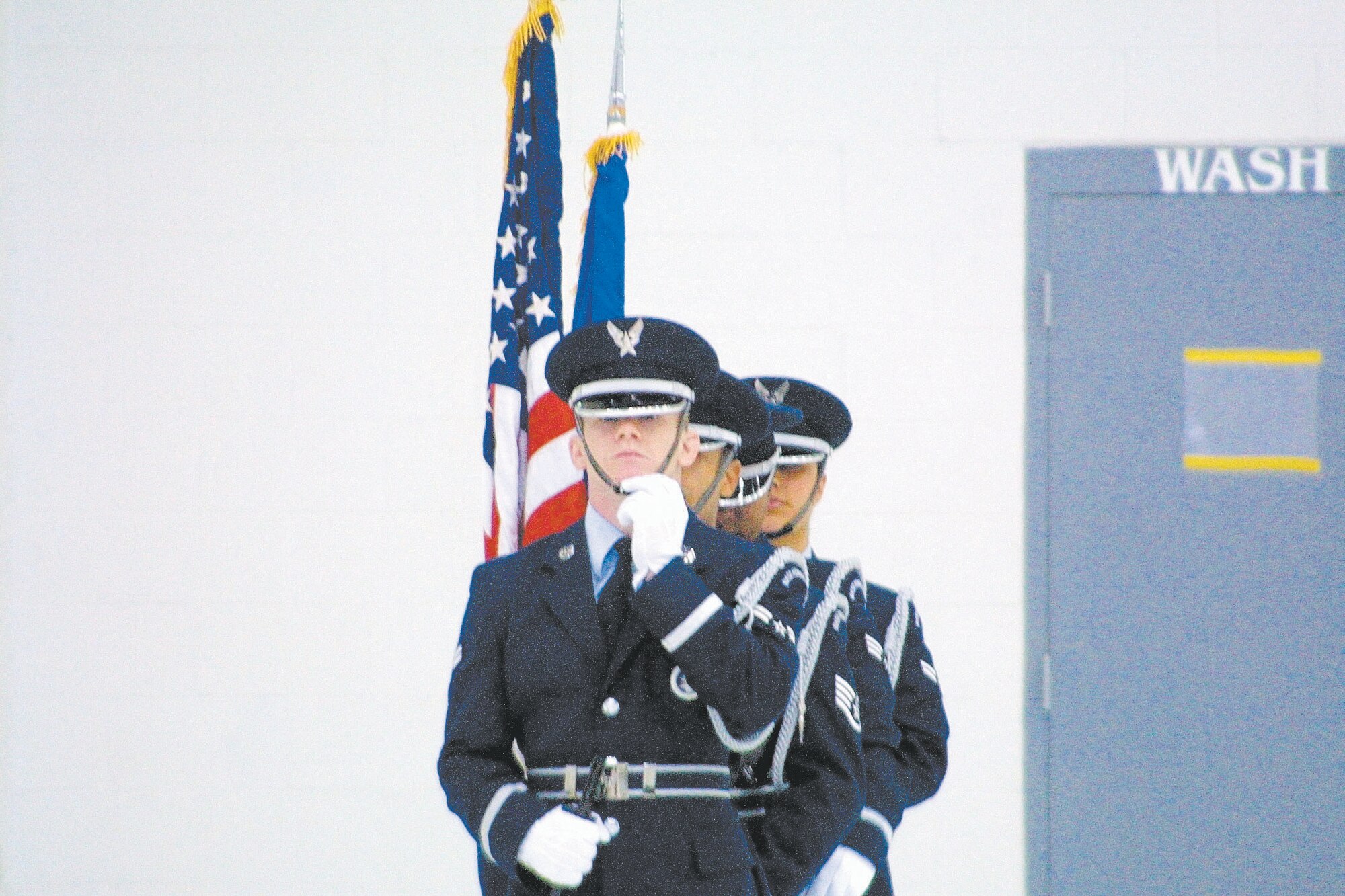 Honor Guard personnel stand by as they wait for a ceremony to begin. They perform Color Guard duties.