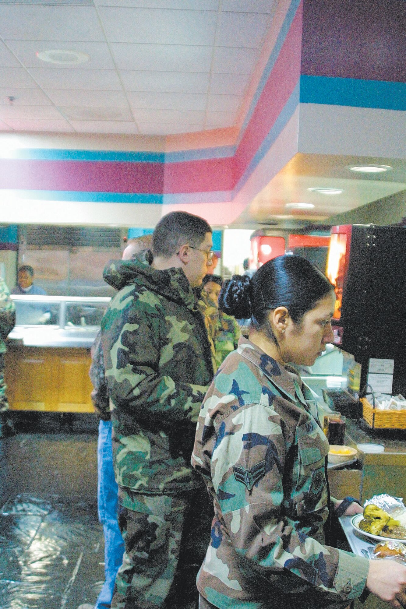 Patrons wait to pay for their food at the Kitty Hawk dining facility. The Kitty Hawk serves meal cardholders and cash-paying enlisted personnel.