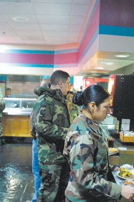 Patrons wait to pay for their food at the Kitty Hawk dining facility. The Kitty Hawk serves meal cardholders and cash-paying enlisted personnel.