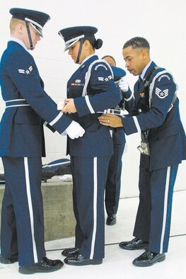 Members of Pope Honor Guard adjust their uniforms before a ceremony.