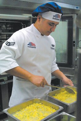Airman 1st Class Andres Elizondogomez stirs a mixture of corn and lima beans in preparation for lunch. The food service personnel begin lunch preparation at 7:30 a.m., and lunch is served from 10:30 a.m. to 1 p.m.