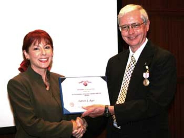 Air Combat Command Chief Scientist, Dr. Janet Fender, recognizes Dr. Forrest “Jack” Agee for 39 years of service to his country.