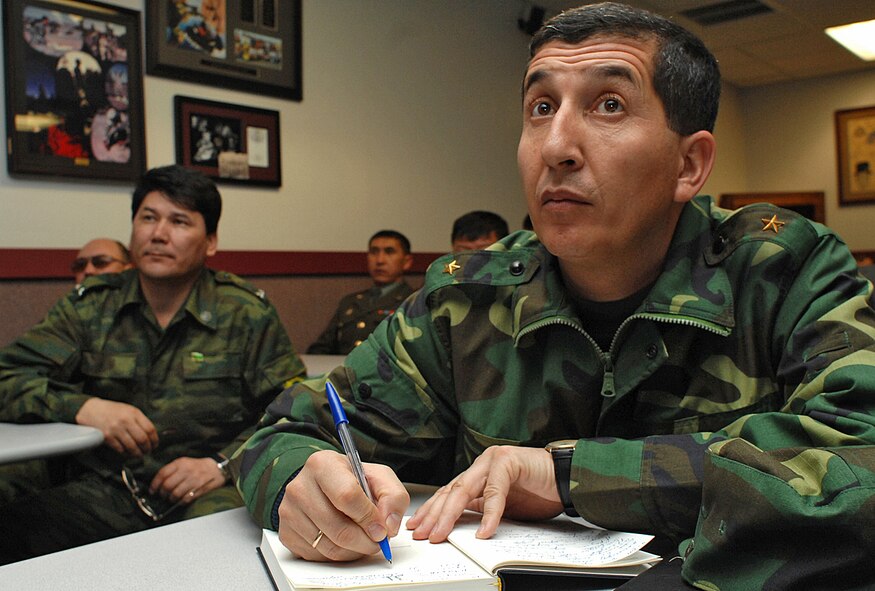 Foreign military visitors from Turkmenistan take notes during a commandant?s brief conducted by Tech. Sgt. Bobbie Ben from the pararescue school here. Many foreign military officials spent time at Kirtland touring everything from the 58th Special Operations Wing to the Base Exchange Feb. 13-14. (U.S. Air Force photo by Todd Berenger)