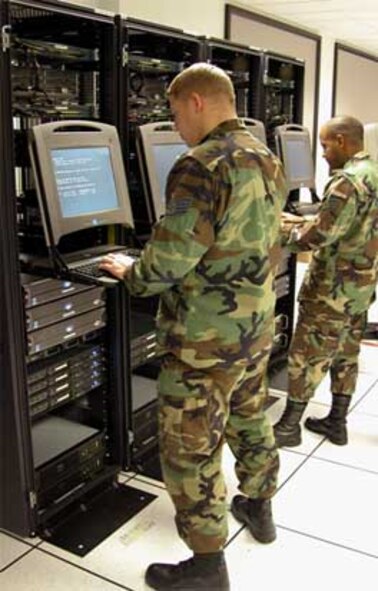 SCOTT AIR FORCE BASE, Ill. -- Staff Sgts. John Cooper, left, and David Jackson from the Air Mobility Command’s network operations and security center , train at the Air Force Communications Agency's technology interoperability facility. (U.S. Air Force photo by Gerald Sonnenberg)