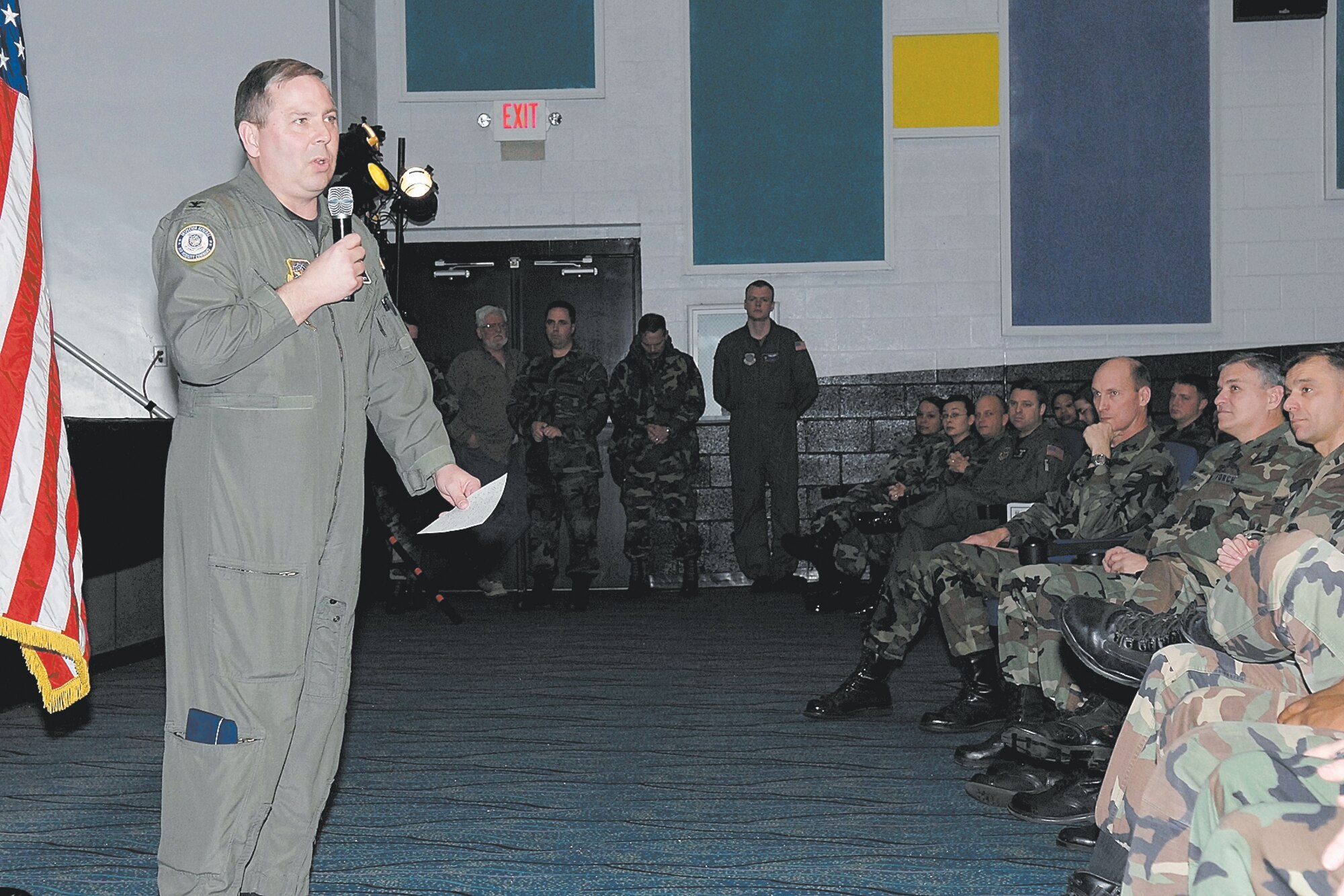 Col. Stan Dougherty, Air Mobility Command inspector general team commander, congratulates Team Pope on their "Excellent" rating on the Unit Compliance Inspection Tuesday. The base theater was filled with people from different units who took pride in their ratings. People brought in clappers, horns and Col. Timothy Zadalis, 43rd Airlift Wing Commander, had the fever for more cow bell.