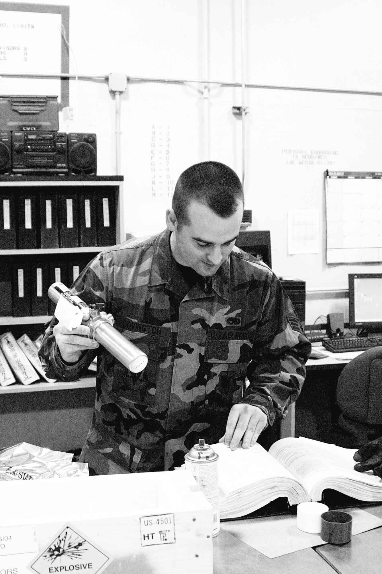 Senior Airman Adam Covington, 23rd Maintenance Squadron, references a manual as he inspects a rocket motor