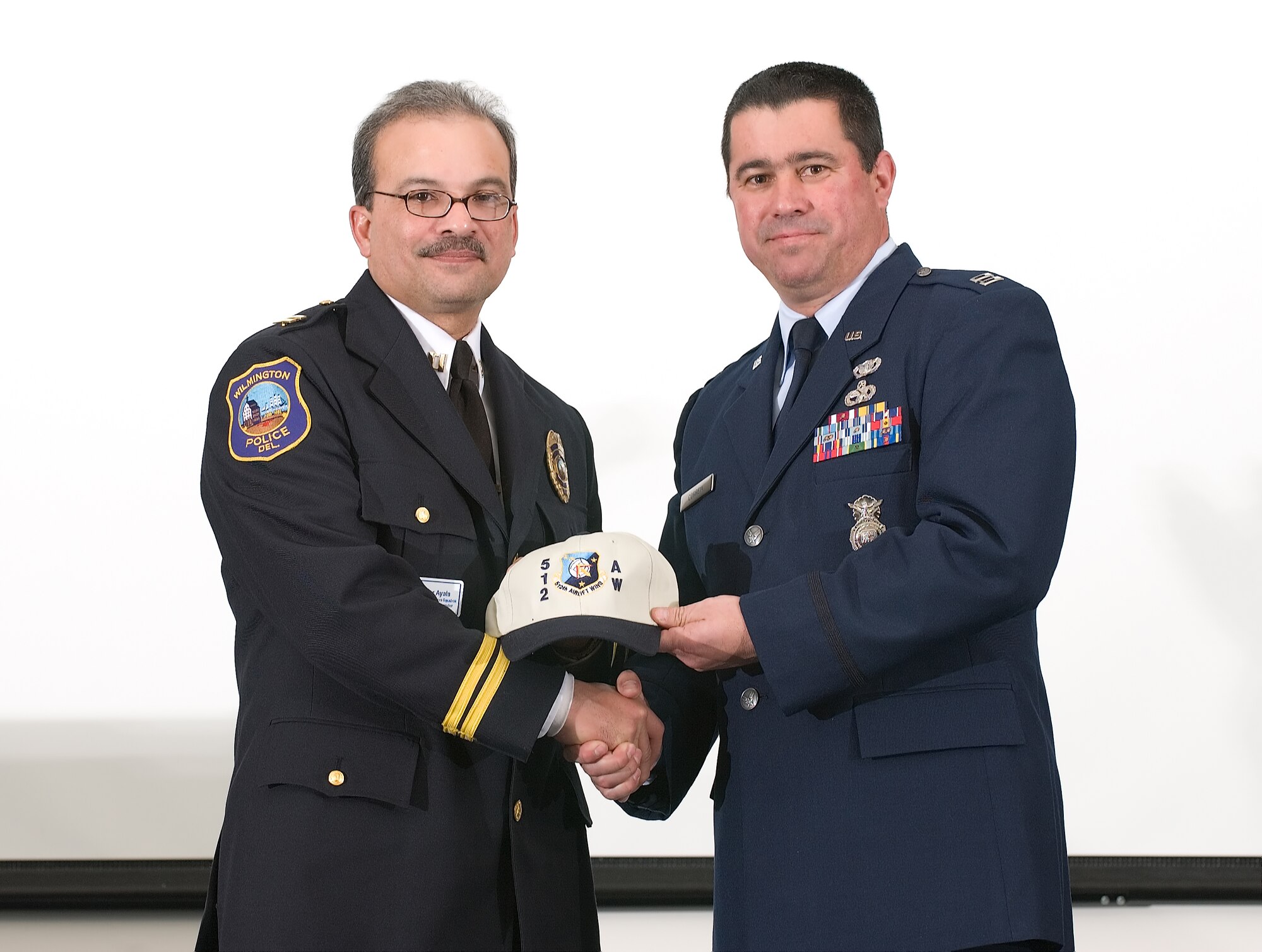 Capt. Randy Correia, 512th Security Forces Squadron commander, welcomes his 2007 honorary commander, Capt. Victor Ayala with the Wilmington Police Department and the commanding officer of the uniform services division. The 512th Airlift Wing, an Air Force Reserve Command unit, and its active-duty counterpart, the 436th Airlift Wing, inducted more than 50 community leaders in the 16th Annual Honorary Commander Induction Ceremony at the Landings Club on Dover Air Force Base, Del., Feb.15 (U.S. Air Force photo by Jason Minto) 
