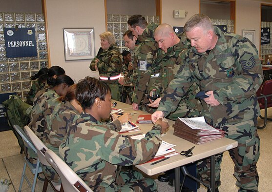 Airman 1st Class LaToya Atkinson, 512th Mission Support Squadron, checks Master Sgt. Bernard Cochran's identification card. Sergeant Cochran,  46th Aerial Port Squadron, was one of 300 512th Airlift Wing members who participated in the deployment exercise Feb. 3. The exercise evaluated the wing's readiness and ability to process through a deployment line, which is preparation for the upcoming Operational Readiness Inspection in October. The 512th Airlift Wing is an Air Force Reserve Command unit. (U.S. Air Force photo by 1st Lt. Marnee A.C. Losurdo)