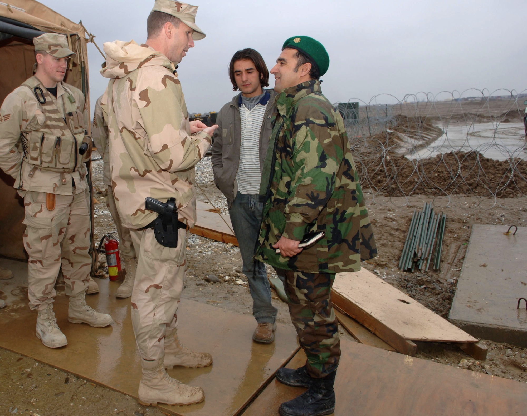 Maj. Corey Ramsby discusses communications infrastructure with Afghan army air corps officers Feb. 20 during a tour of the airfield at Bagram Air Base, Afghanistan. Major Corey is the 54th Expeditionary Combat Communications Squadron commander. (U.S. Air Force photo/Staff Sgt. Kevin Tomko)