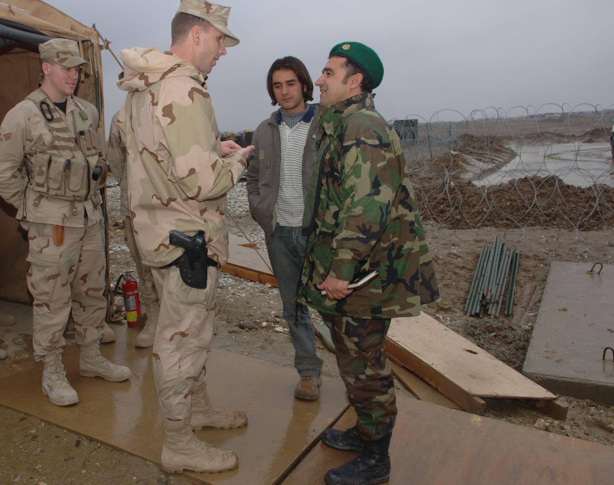Maj. Corey Ramsby, 54th Expeditionary Combat Communications Squadron commander, discusses Bagram's communications infrastructure with his Afghan army air corps equivalent during a tour of the airfield Feb. 20. (U.S. Air Force photo/Staff Sgt. Kevin Tomko)