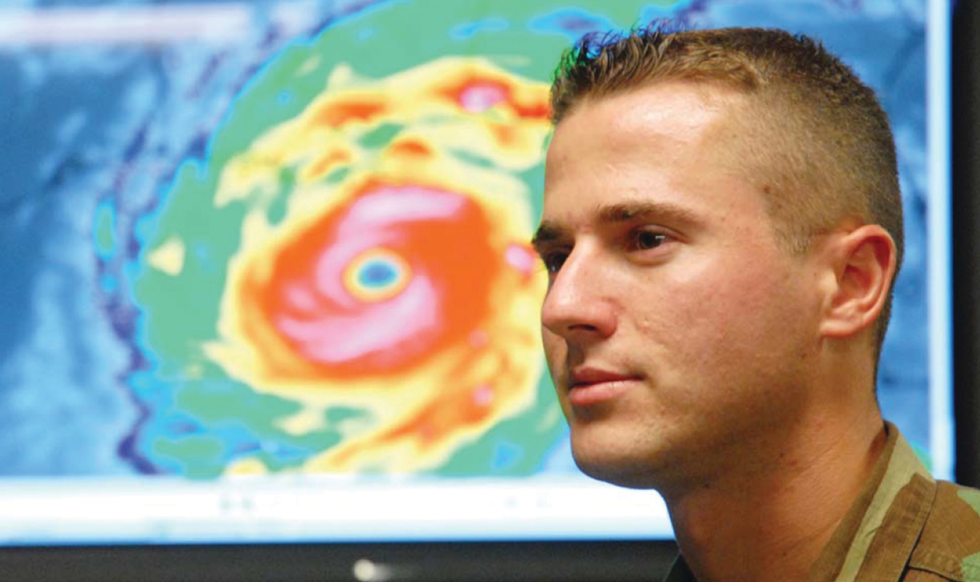 Second Lt. Doug Gautrau, 26th Operational Weather Squadron, stands in front of an infared satellite image of Hurricane Katrina in the briefing room of the 26th OWS.