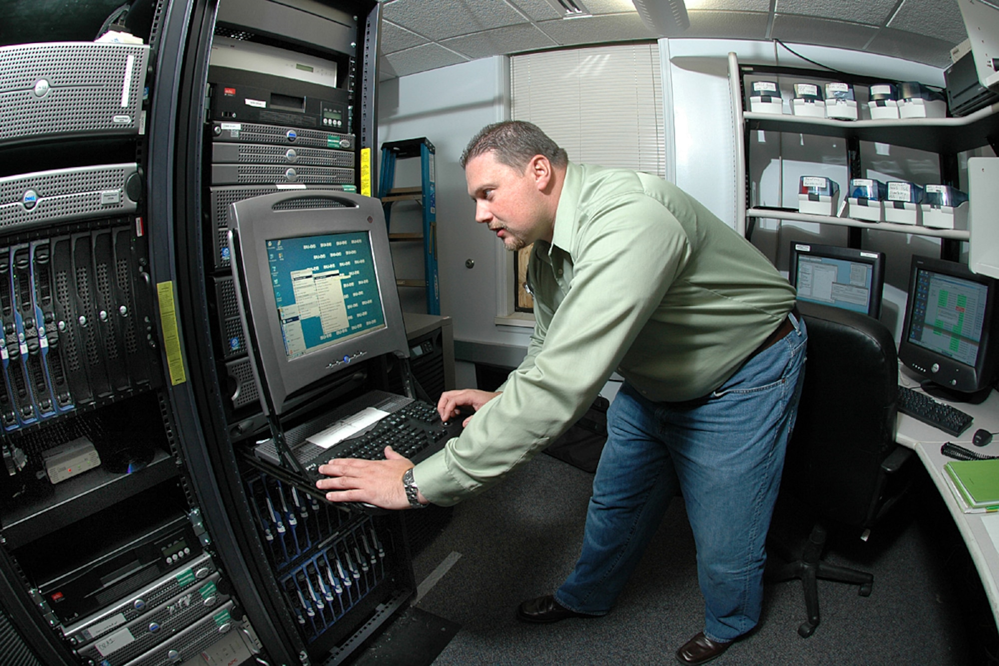 Mr. Norman Watts, a 15th Operational Weather Squadron network/system administrator, checks the squadron’s server performance. The squadron uploads more than 120,000 files (10 Gbytes) daily. Photo by Mr. Marv Lynchard.