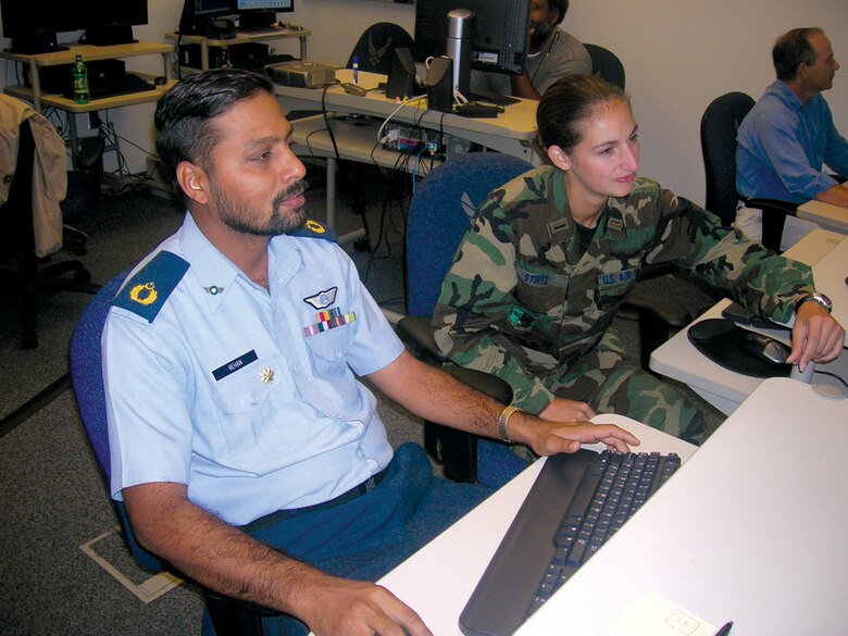 2nd Lt. Holly Stirtz demonstrates several web-based weather data sources for Maj. Muhammad Rehan Ashraf.