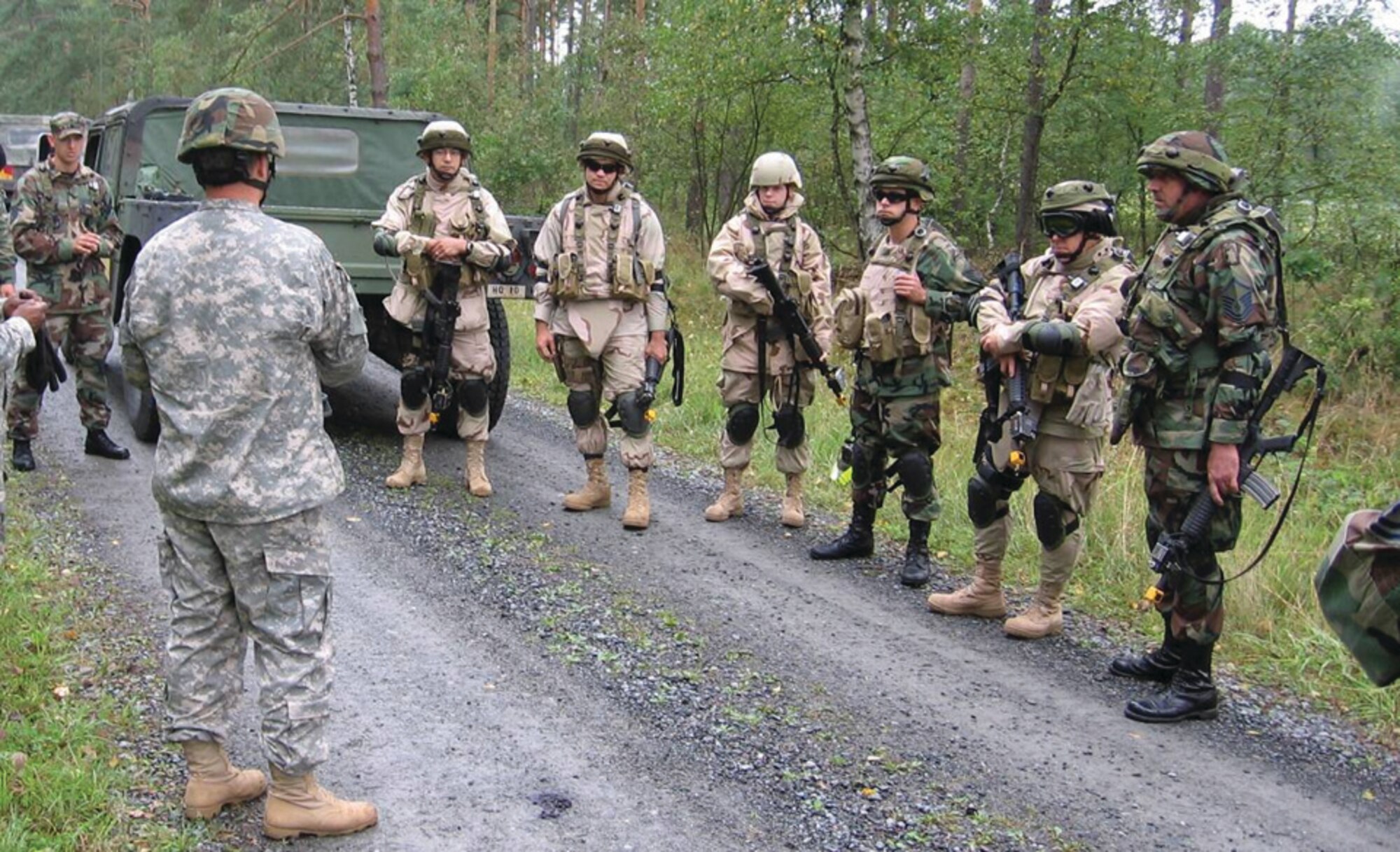 Second from the left, Army Sgt. First Class David Gavit and left, Staff Sgt. Derek Dinger review lessons learned from a convoy scenario.