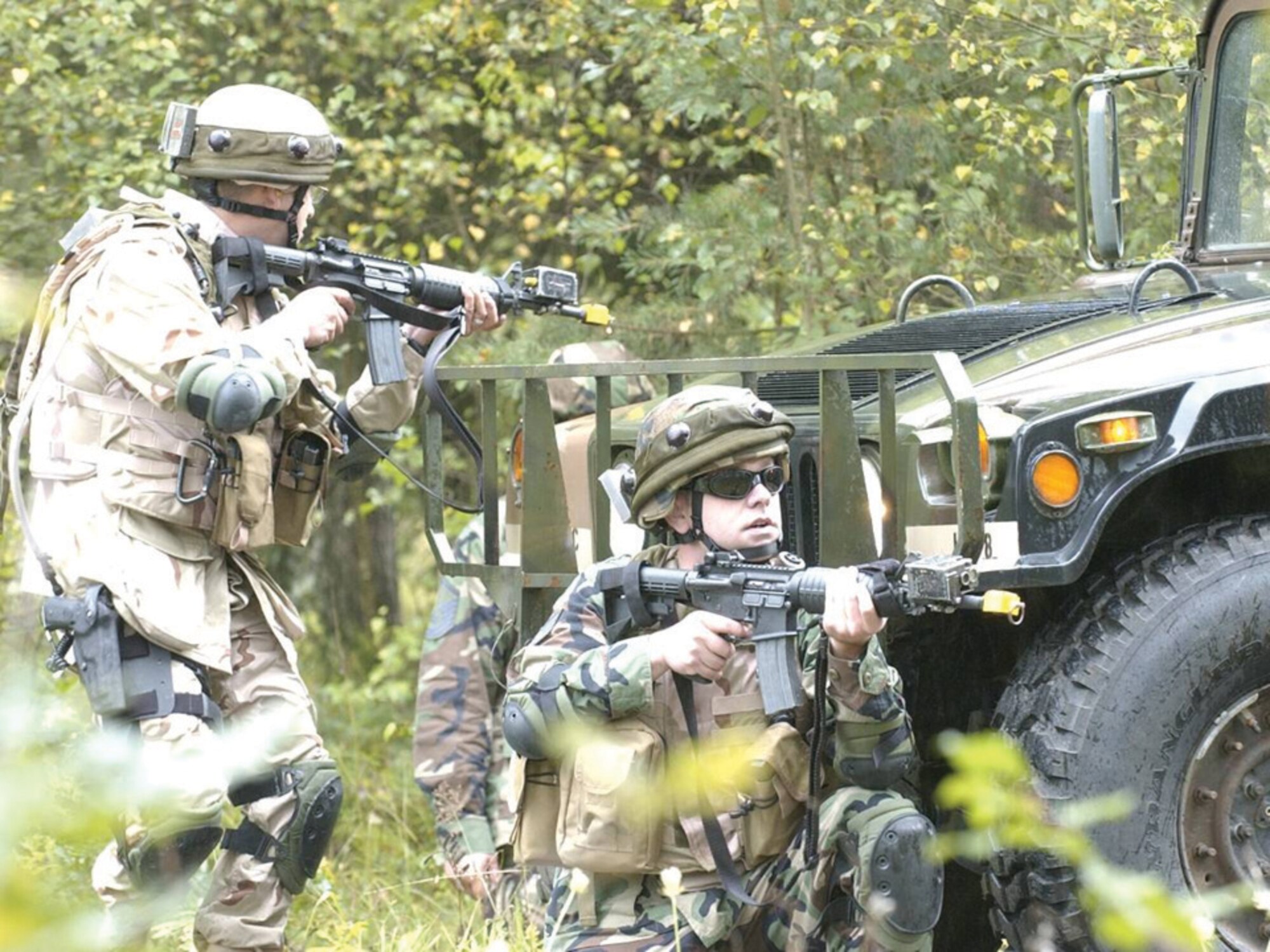 Maj. Jose Harris and, right, Staff Sgt. Josh Smith take a defensive position during convoy training. Photos courtesy of 7th Weather Squadron.