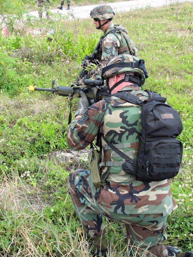 An Airman peers down the sight of his M4 rifle Feb. 26 during training at Andersen Air Force Base, Guam,. Airmen from the 36th Contingency Response Group participated in a series of battle drills to hone their combat skills. (U.S. Air Force photo/Army Sgt. Catherine Talento)