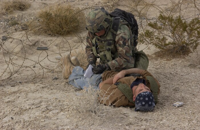Airmen 1st Class Chad Matlock, 47th Security Forces Squadron, Laughlin Air Force Base, Texas, conducts a body search on a simulated enemy casualty at a Ground Combat Training Squadron exercise at Creech AFB, Nev., on Feb 18, 2007.  The Ground Combat Training Squadron is responsible for training and testing security forces personnel on procedures for real-world scenarios that they will encounter during a deployment. (U.S Air Force Force photo by Airman 1st Class Nadine Y. Barclay)
