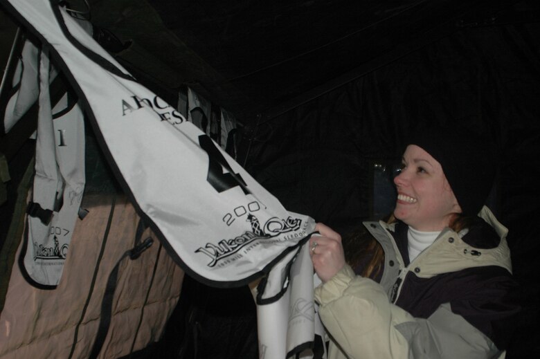 EIELSON AIR FORCE BASE, Alaska--Senior Airman Cheryl Hoellwarth, 354th Services Squadron fitness specialist and volunteer for the event, sorts through bibs to give to mushers Feb. 20 at the Dog Drop, the last checkpoint in the Yukon Quest before the finish line in Fairbanks. The Yukon Quest is a 1,000-mile international sled dog race held annually in Alaska. Mushers race through territory from Whitehorse to Fairbanks. (U.S. Air Force photo by Staff Sgt. Gloria Wilson)