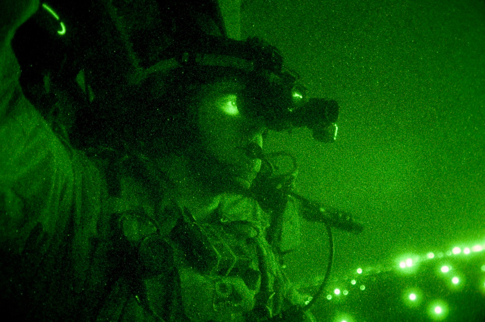 A pararescue jumper, equipped with night vision goggles, scans the Iraqi terrain during a combat search and rescue rehearsal mission Feb. 24 outside Balad Air Base, Iraq. He and his teammates use these rehearsal missions to stay proficient. They are assigned to the 64th Expeditionary Rescue Squadron. (U.S. Air Force photo/Tech. Sgt. Cecilio M. Ricardo Jr.)