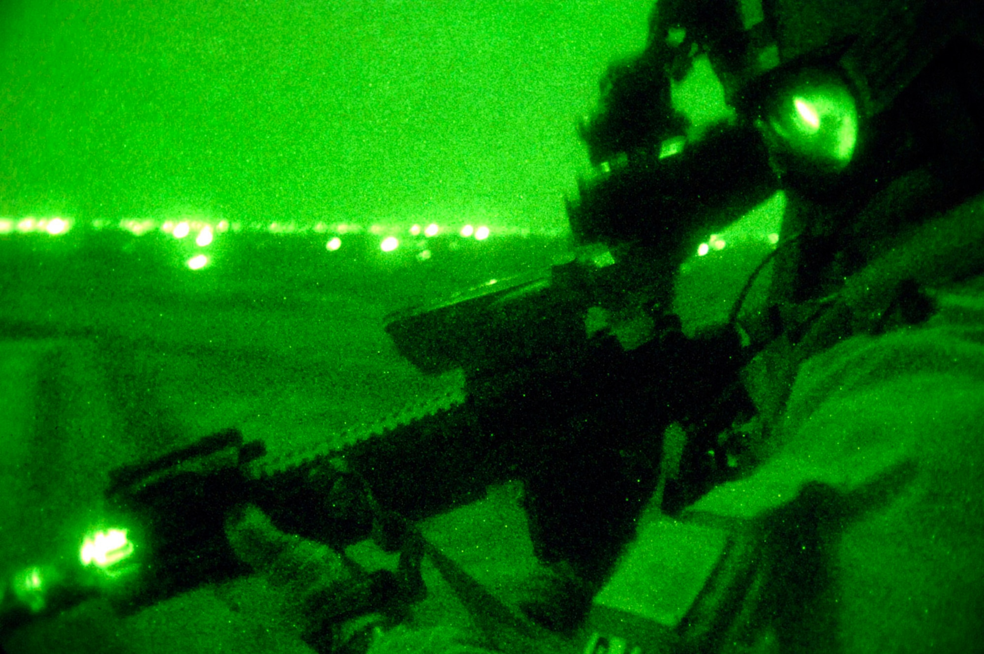 A pararescue jumper, equipped with night vision goggles, scans the Iraqi terrain during a combat search and rescue rehearsal mission Feb. 24 outside Balad Air Base, Iraq. He and his teammates use these rehearsal missions to stay proficient. They are assigned to the 64th Expeditionary Rescue Squadron. (U.S. Air Force photo/Tech. Sgt. Cecilio M. Ricardo Jr.)