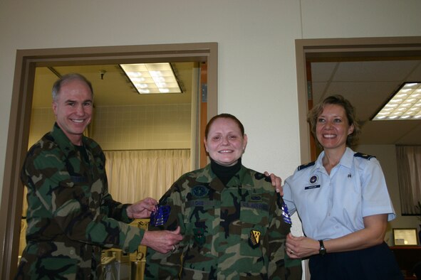 Staff Sgt. Holly Long, a physical education instructor for the 382nd Training Squadron, has her technical sergeant stripes pinned on by 82nd Training Wing commander Brig. Gen. Richard Devereaux and 382nd TRS course supervisor Maj. Michelle Kastler. (U.S. Air Force photo/Staff Sgt. Tonnette Thompson)