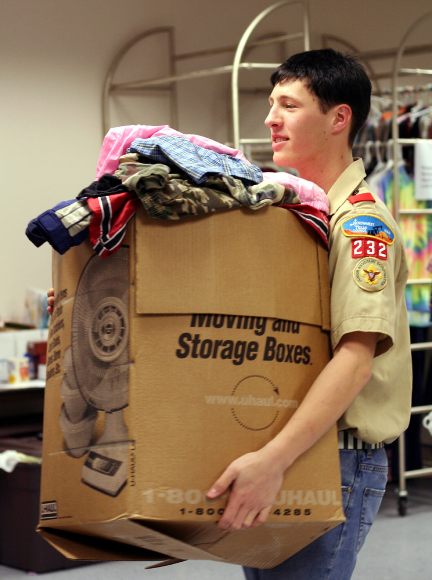 Neil Kendall, a Boy Scout with Troop 232 on Sheppard, makes room for more donated items Feb. 24. Neil, the son of 80th Flying Training Wing Commander Col. Jeffrey and Lori Kendall, organized a drive to collect various items from base housing areas for delivery to the Airman's Attic. (U.S. Air Force photo/Adrian McCandless)