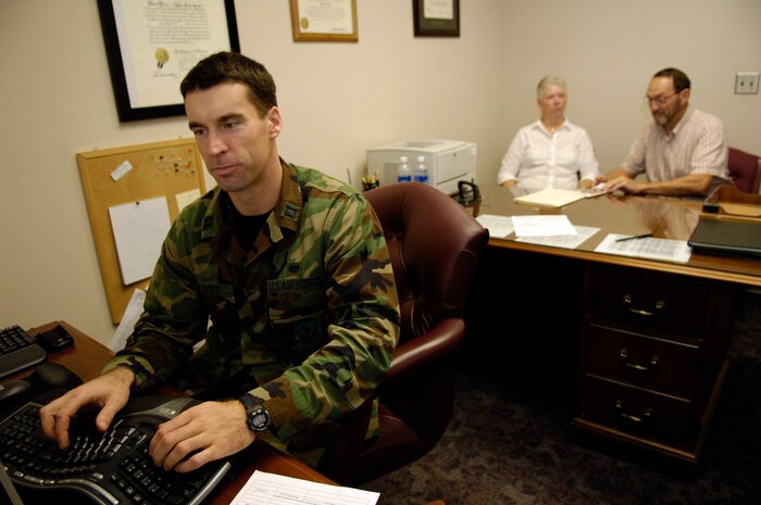 Capt. John Scott, chief of legal claims, reviews the will of Keith and Ann Ashton, at the 437th Airlift Wing Legal Office recently. (U.S. Air Force photo by Staff Sgt. Stacy L. Pearsall)