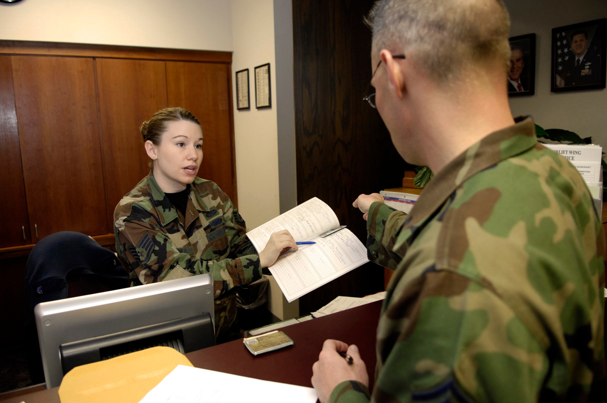 Staff Sgt. Charity Barnett, 437th Airlift Wing military justice paralegal, provides assistance to Senior Master Sgt. Chris Dearman, 437th Maintenance Squadron Fabrication Flight chief, at the Legal Office recently. The Legal Office claimed the 2006 award for the Best Overall Military Justice Program in Air Mobility Command for the second consecutive year.(U.S. Air Force photo by Staff Sgt. Stacy L. Pearsall)