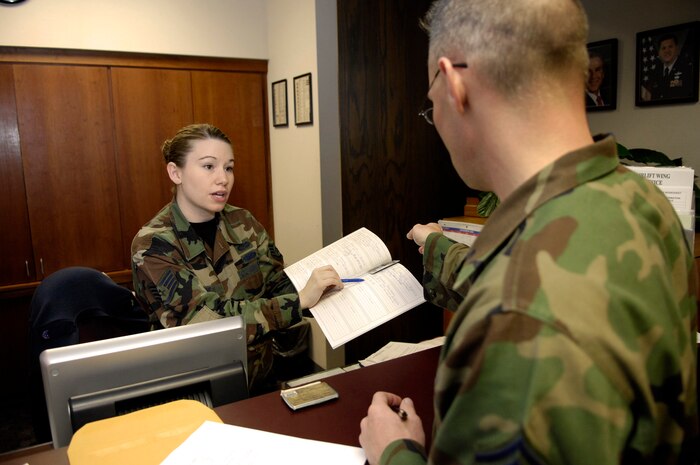 Staff Sgt. Charity Barnett, 437th Airlift Wing military justice paralegal, provides assistance to Senior Master Sgt. Chris Dearman, 437th Maintenance Squadron Fabrication Flight chief, at the Legal Office recently. The Legal Office claimed the 2006 award for the Best Overall Military Justice Program in Air Mobility Command for the second consecutive year.(U.S. Air Force photo by Staff Sgt. Stacy L. Pearsall)