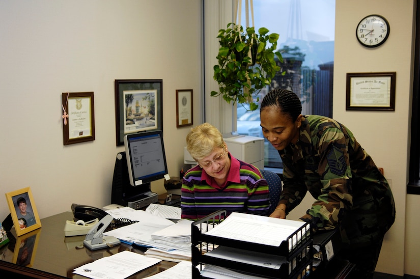 JoAnne LaMunion and Master Sgt. Carla Thornton, legal claims office personnel, look over some paperwork at the legal office recently. (U.S. Air Force photo by Staff Sgt. Stacy L. Pearsall)