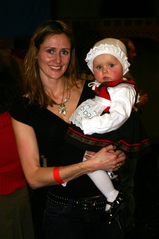 Monica Alstad, spouse of Capt. Tommy Alstad, 88th FTS, shows off her daughter Maya's "bunad" costume during the Around the World Celebration at the Sheppard Club Feb. 24. (U.S. Air Force Photo/Staff Sgt. Tonnette Thompson)
