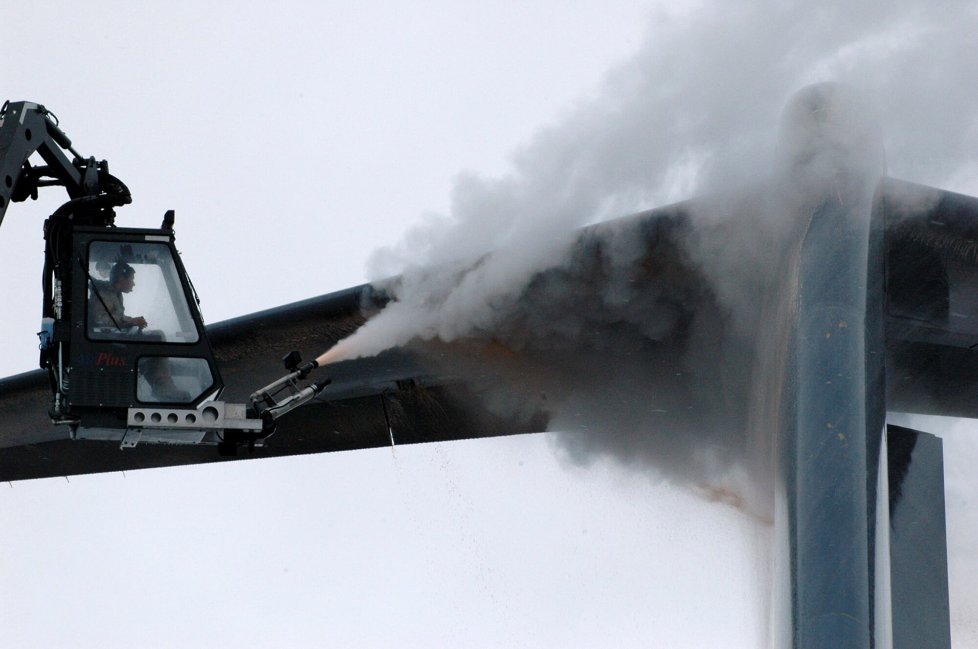 Airman 1st Class David Rosas de-ices a C-17 Globemaster III Feb. 20 prior to an airlift mission.  Airman Rosas' de-icing cabin is suspended from the end of a 80-foot lift truck.  He is with the 817th Expeditionary Airlift Squadron and is deployed from the 62nd Aircraft Maintenance Squadron at McChord Air Force Base, Wash.  (U.S. Air Force Photo/Master Sgt. Daniel Nathaniel)
