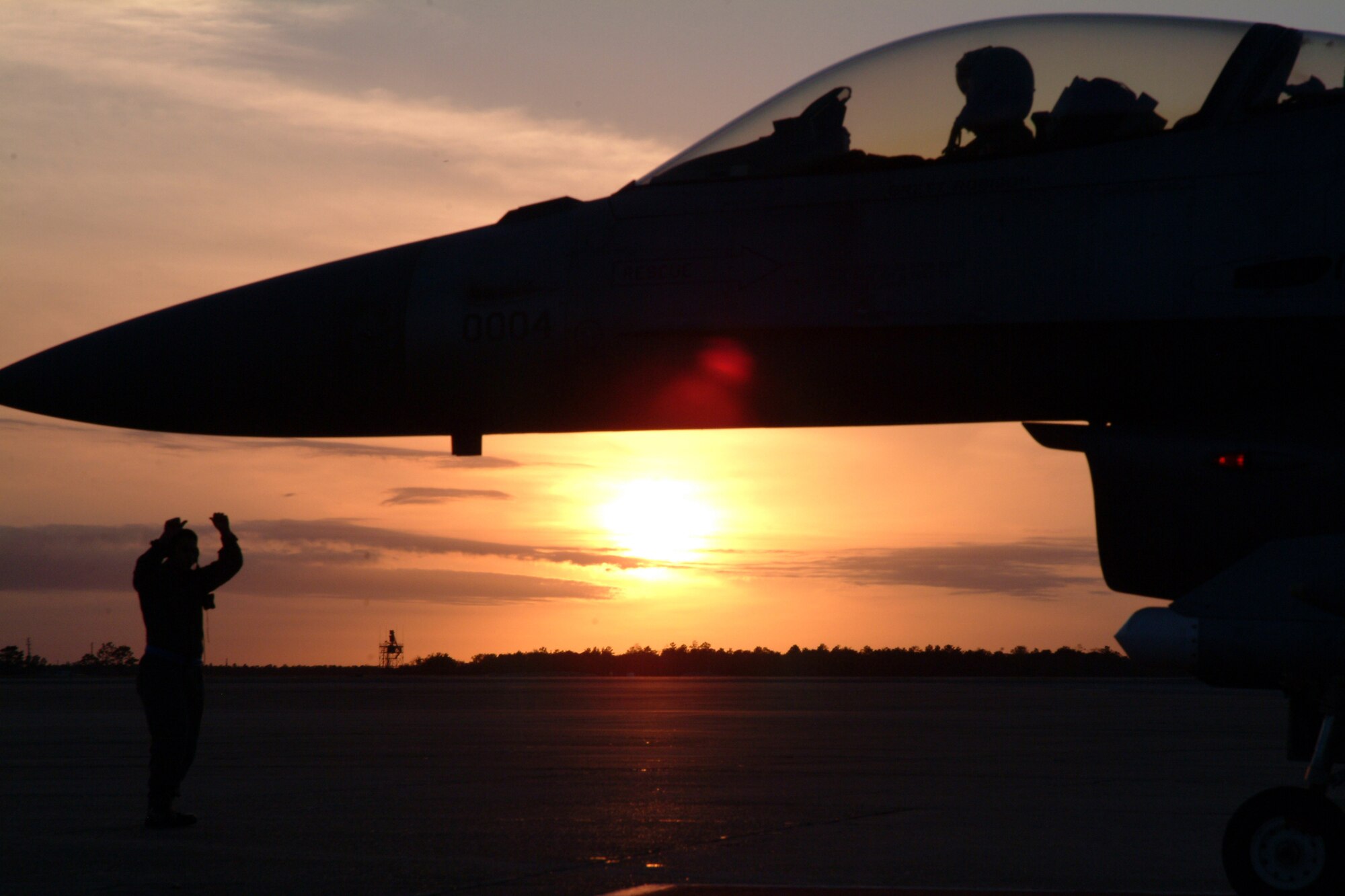 EGLIN AFB, Fla. – Lt. Col. Anthony Franzel, 53d Wing Safety Office chief, brings his F-16C Fighting Falcon to a stop one final time, guided by crew chief Airman 1st Class Steven Sisneros, 46th Aircraft Maintenance Squadron, after his fini-flight Feb. 26 at Eglin AFB, Fla.  The flight marks just more than 2,200 flying hours for Colonel Franzel’s 21-year Air Force career. He retires May 1. (U.S. Air Force photo by Tech. Sgt. Andrew Leonhard) 