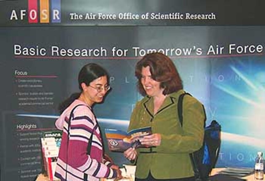 Dr. Kathleen Kaplan, Program Manager, External Programs & Resources Interface, Air Force Office of Scientific (AFOSR), discusses AFOSR's grant portfolio for graduate and post graduate students with a student attendee at the 44th National Junior Science and Humanities Symposium held April 26-30 in Albuquerque, New Mexico. (Air Force photo by Erin Crawley)