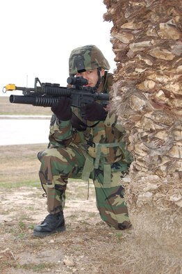 Senior Airman Abel Anaya, an M-203 grenadier with the 433rd Security Forces Squadron, provides over-watch security during a patrol exercise. Airman Anaya's job during the excercise was to provide cover to his team mates at an entry control point. (U.S. Air Force Photo/Master Sgt. Collen McGee)