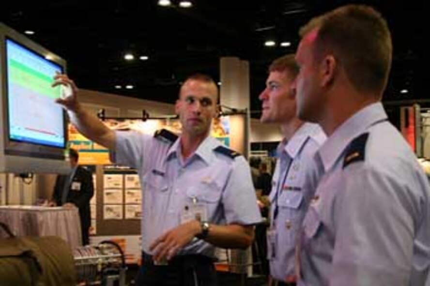 AFRL Human Effectiveness Directorate Major Dan Watola and Second Lieutenants Andrew Cantwell and Andrew Workman spoke to a Special Operations Combat Control Team member about the Combat Oxygen system that AFRL is researching. 