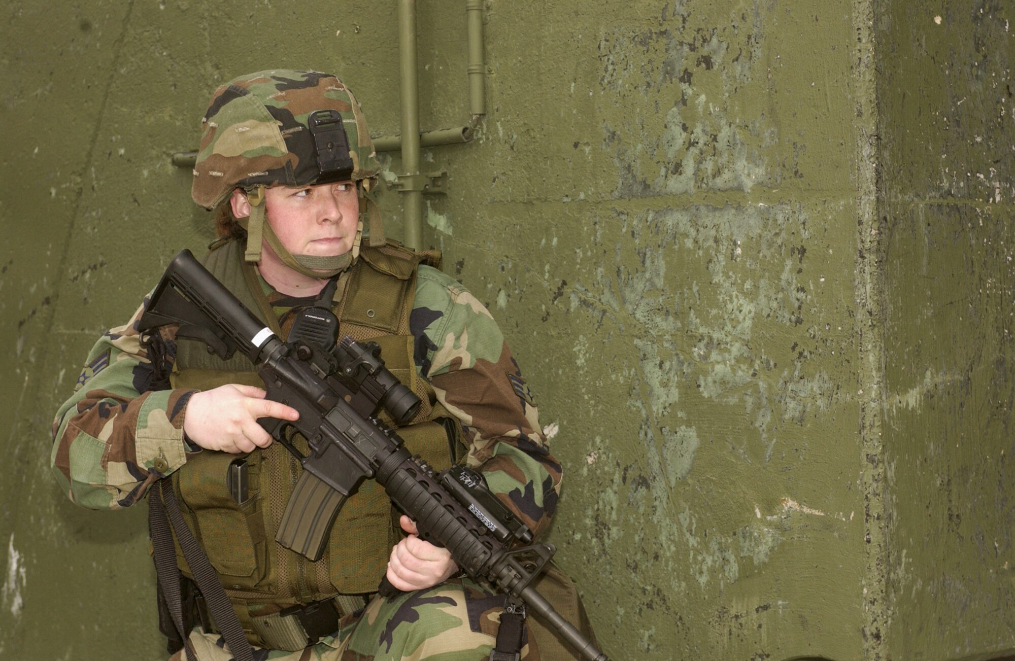 Senior Airman Arika Moats, 702nd Munitions Support Squadron Security Forces Operations, Buechel Air Base, Germany, waits for reinforcement in order to recapture a protected aircraft shelter which has been overtaken by terrorists in an exercise, Feb. 21, 2007.  (U.S. Air Force photo by Senior Airman Kristin Ruleau) 