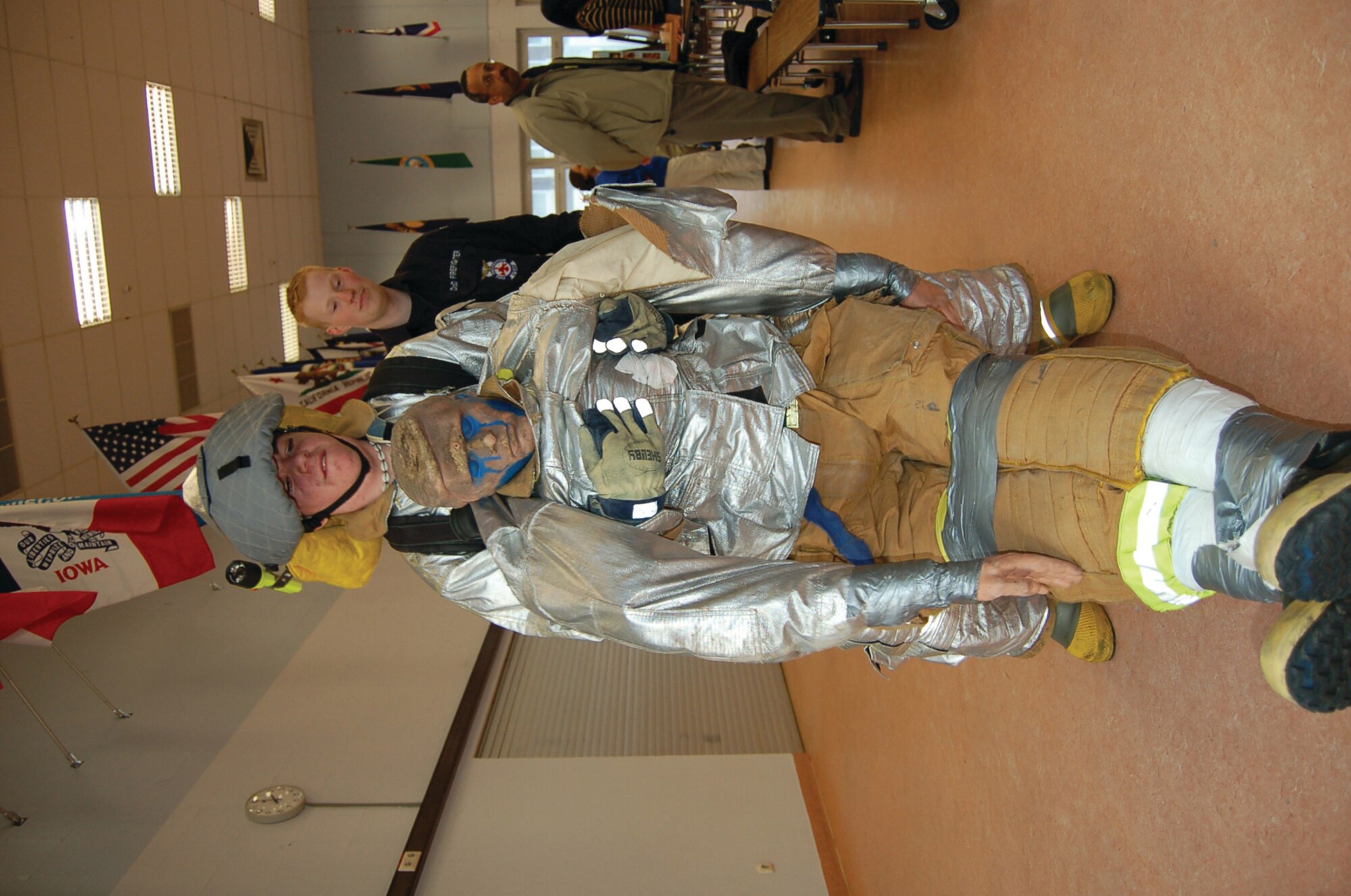 Andrew Morman, Bitburg High School junior and son of Tech. Sgt. Jeffery Morman, 52nd Equipment Maintenance Squadron, attempts to move a "victim" as Florian Wintrich, 52nd Civil Engineer Squadron firefighter, watches during a Career and a Future event. (US Air Force photo by Senior Airman Eydie Sakura)