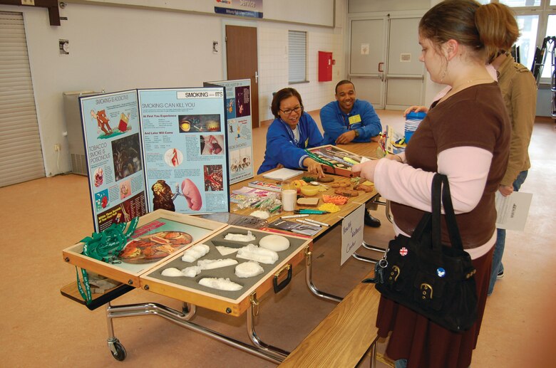 Staff Sgts. Suzy Bright and Joe Canteen, both from the Health and Wellness Center, talk to Bitburg High School students about healthy lifestyle choices during a Planning for a Career and a Future event. Sergeant Bright is a diet therapy technician and Sergeant Canteen is the tobacco sensation facilitator. (US Air Force photo by Senior Airman Eydie Sakura)