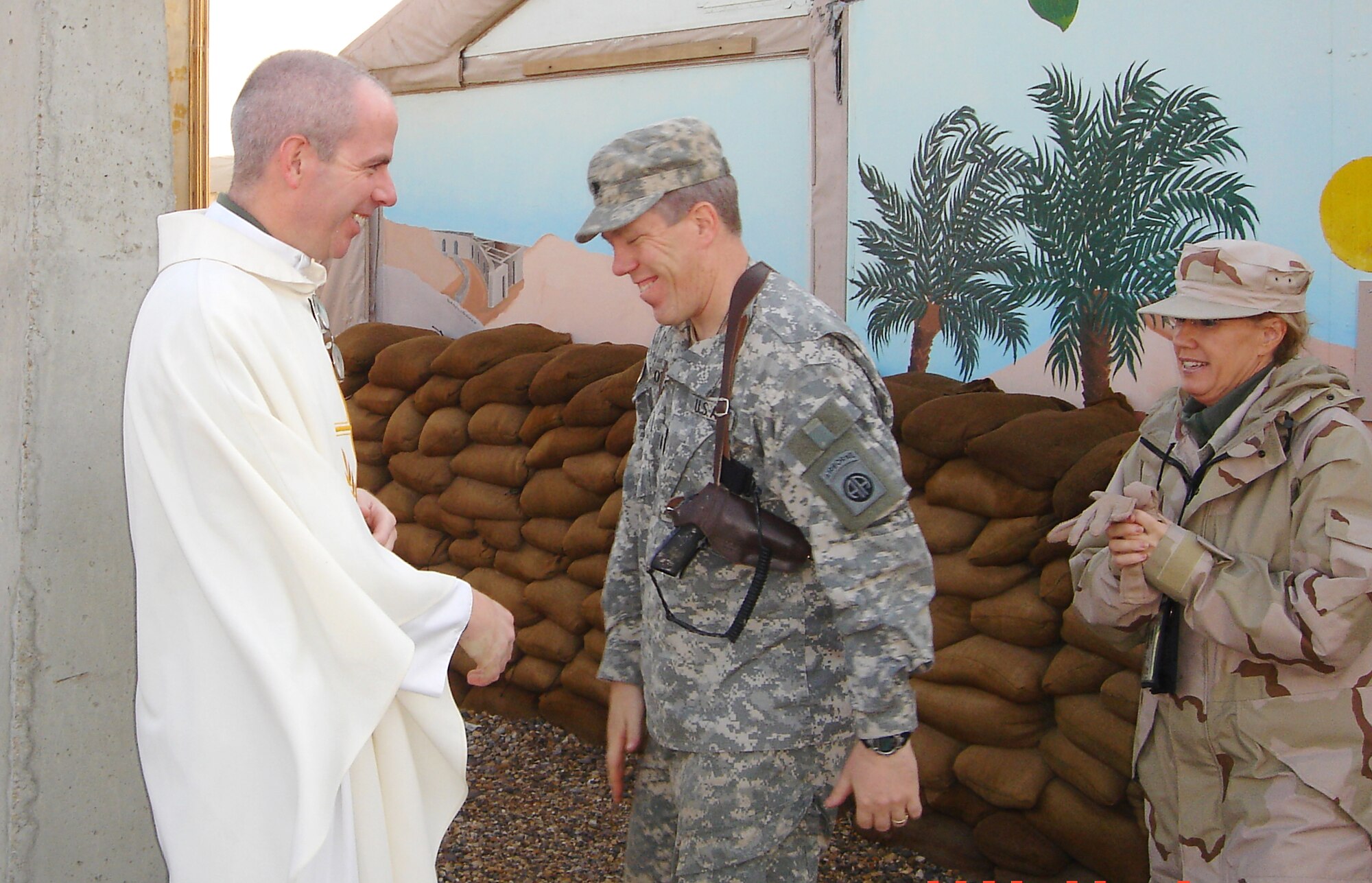 Chaplain Hamel greets his “parishioners” after morning Mass in the Oasis of Peace Chapel, at Ali Base, in south-central Iraq. As the only Catholic chaplain for about 600 Air Force members at Ali Base, Father Hamel said his workload was “steady, but not overwhelming.”